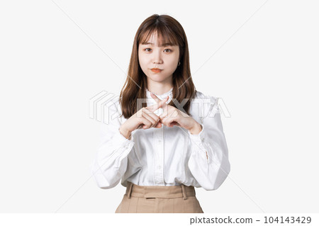 Young Japanese business woman doing a cross pose with her fingers 104143429