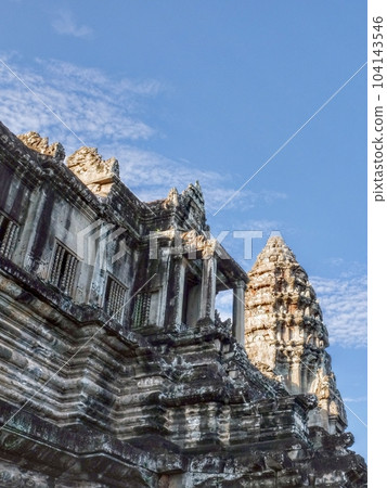 Carved stone walls of the ancient Angkor Temple complex in Cambodia. 104143546