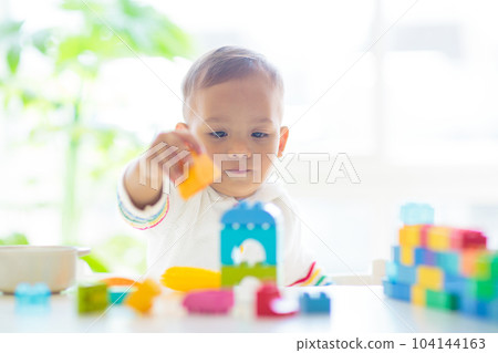 Baby boy playing with toy 104144163