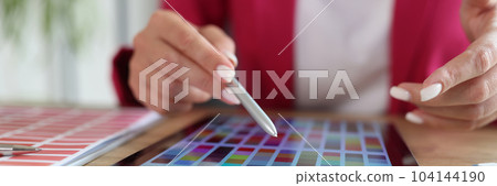 Woman working with color swatches for selection on tablet Woman working with color swatches for selection on tablet 104144190
