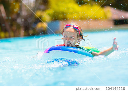 Child in swimming pool on toy ring. Kids swim. Child in swimming pool on toy ring. Kids swim. 104144218
