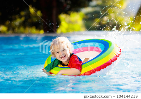 Child in swimming pool on toy ring. Kids swim. Child in swimming pool on toy ring. Kids swim. 104144219