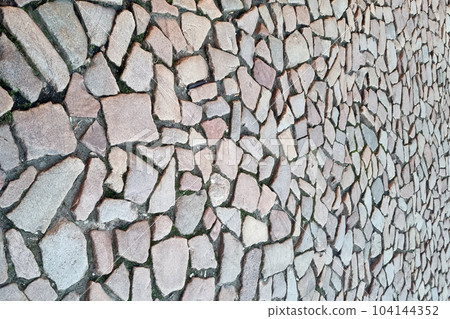 The texture of the street tiles of the old street. The background of the stones. 104144352
