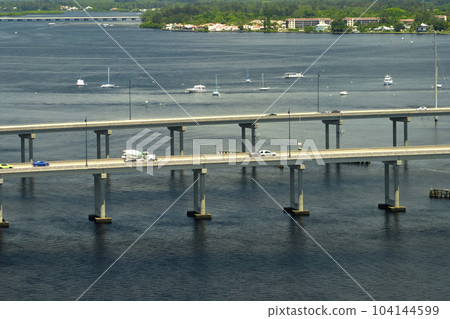 Barron Collier Bridge and Gilchrist Bridge in Florida with moving traffic. Transportation infrastructure in Charlotte County connecting Punta Gorda and Port Charlotte over Peace River Barron Collier Bridge and Gilchrist Bridge in Florida with moving traffic. Transportation infrastructure in Charlotte County connecting Punta Gorda and Port Charlotte over Peace River 104144599