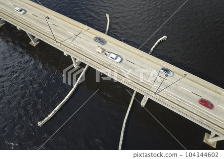 Barron Collier Bridge and Gilchrist Bridge in Florida with moving traffic. Transportation infrastructure in Charlotte County connecting Punta Gorda and Port Charlotte over Peace River Barron Collier Bridge and Gilchrist Bridge in Florida with moving traffic. Transportation infrastructure in Charlotte County connecting Punta Gorda and Port Charlotte over Peace River 104144602