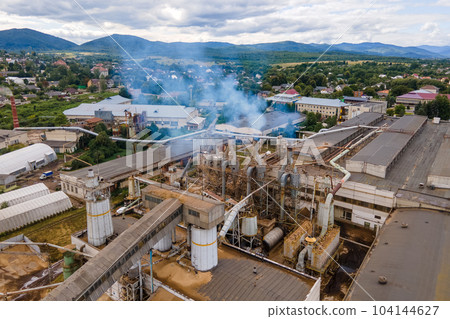 Aerial view of wood processing plant with smokestack from production process polluting environment at factory manufacturing yard 104144627