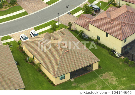 Aerial view of typical contemporary american private house with roof top covered with ceramic shingles and double garage 104144645