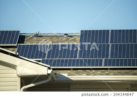 Aerial view of typical american building roof with rows of blue solar photovoltaic panels for producing clean ecological electric energy. Renewable electricity with zero emission concept 104144647