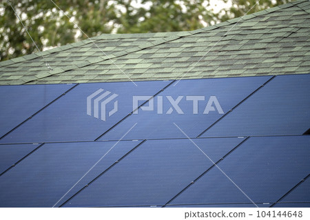 Aerial view of typical american building roof with blue solar photovoltaic panels for producing clean ecological electric energy. Investing in renewable electricity for retirement income concept 104144648