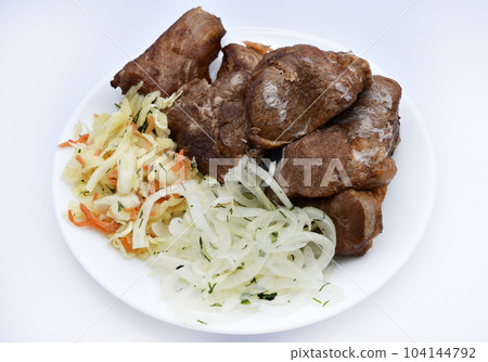 Beautiful fried pieces of pork meat. Pork kebab with vegetables. Meat on a plate. 104144792