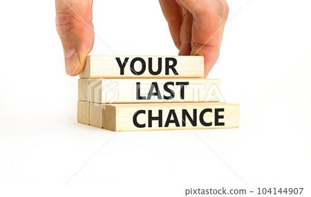 Time to your last chance symbol. Concept words Your last chance on wooden blocks on a beautiful white table white background. Businessman hand. Business and your last chance concept. Copy space. Time to your last chance symbol. Concept words Your last chance on wooden blocks on a beautiful white table white background. Businessman hand. Business and your last chance concept. Copy space. 104144907