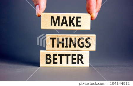 Make things better symbol. Concept words Make things better on wooden block on a beautiful grey table grey background. Businessman hand. Business and make things better concept. Copy space. Make things better symbol. Concept words Make things better on wooden block on a beautiful grey table grey background. Businessman hand. Business and make things better concept. Copy space. 104144911
