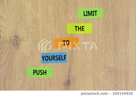 Push the limit symbol. Concept words Push yourself to the limit on colored paper. Beautiful wooden table wooden background. Business push the limit concept. Copy space. Push the limit symbol. Concept words Push yourself to the limit on colored paper. Beautiful wooden table wooden background. Business push the limit concept. Copy space. 104144938