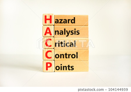 HACCP symbol. Concept words HACCP hazard analysis critical control point on wooden block. Beautiful white background. Business HACCP hazard analysis critical control point concept. Copy space. HACCP symbol. Concept words HACCP hazard analysis critical control point on wooden block. Beautiful white background. Business HACCP hazard analysis critical control point concept. Copy space. 104144939