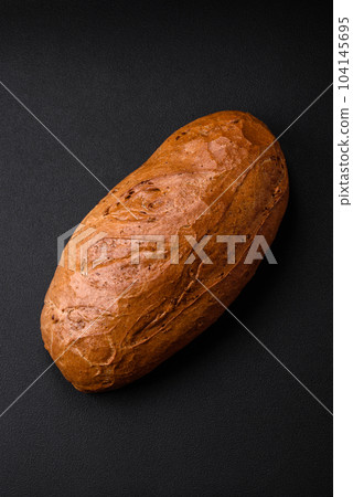 Delicious fresh crispy loaf of white bread with grains and seeds 104145695