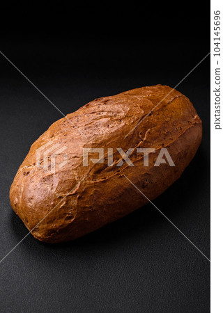 Delicious fresh crispy loaf of white bread with grains and seeds Delicious fresh crispy loaf of white bread with grains and seeds 104145696
