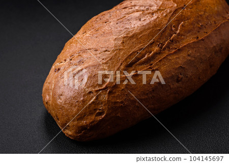 Delicious fresh crispy loaf of white bread with grains and seeds Delicious fresh crispy loaf of white bread with grains and seeds 104145697