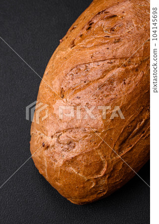 Delicious fresh crispy loaf of white bread with grains and seeds Delicious fresh crispy loaf of white bread with grains and seeds 104145698