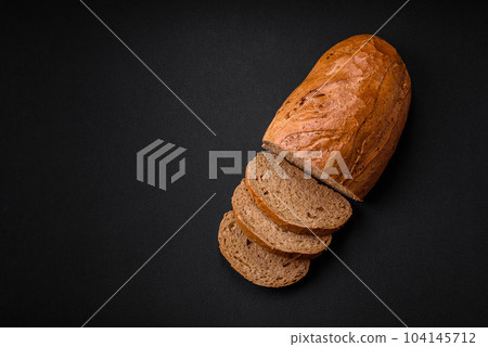 Delicious fresh crispy loaf of white bread with grains and seeds 104145712