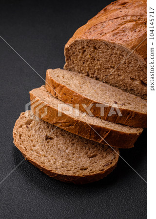 Delicious fresh crispy loaf of white bread with grains and seeds Delicious fresh crispy loaf of white bread with grains and seeds 104145717