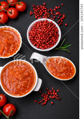 Delicious spicy tomato sauce with pepper, garlic, salt, spices and herbs 104145745