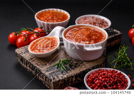 Delicious spicy tomato sauce with pepper, garlic, salt, spices and herbs 104145746