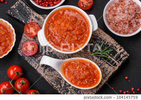 Delicious spicy tomato sauce with pepper, garlic, salt, spices and herbs Delicious spicy tomato sauce with pepper, garlic, salt, spices and herbs 104145759