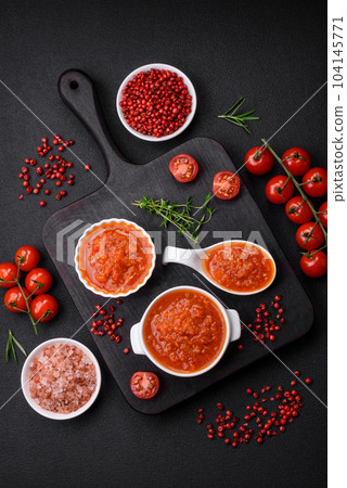 Delicious spicy tomato sauce with pepper, garlic, salt, spices and herbs Delicious spicy tomato sauce with pepper, garlic, salt, spices and herbs 104145771