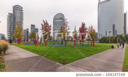 Panorama showing skyscrapers and biblioteca from park with green lawn timelapse in Milan Panorama showing skyscrapers and biblioteca from park with green lawn timelapse in Milan 104147149