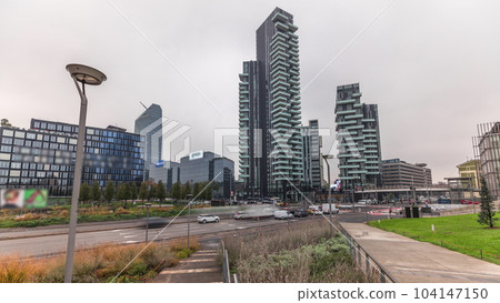 Panorama showing skyscrapers and biblioteca from park with green lawn timelapse in Milan Panorama showing skyscrapers and biblioteca from park with green lawn timelapse in Milan 104147150