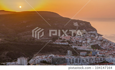 Aerial sunrise view of the coastline of the village of Sesimbra timelapse. Portugal 104147164