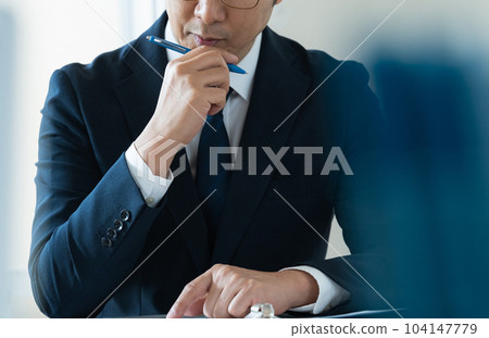 businessman thinking about business strategy businessman thinking about business strategy 104147779