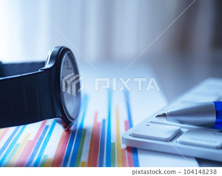 Graph, keyboard and clock on the table 104148238