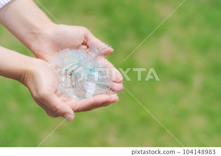 Hand photo with a piece of plastic 104148983