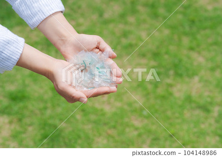 Hand photo with a piece of plastic 104148986