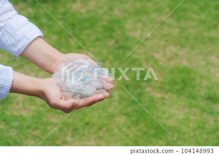 Hand photo with a piece of plastic Hand photo with a piece of plastic 104148993