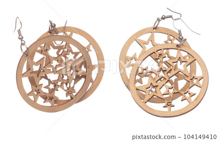 Fashion wooden Earrings with beautiful work detail is value. Luxury wooden star earring is fashion trend and fly in air. White background isolated 104149410