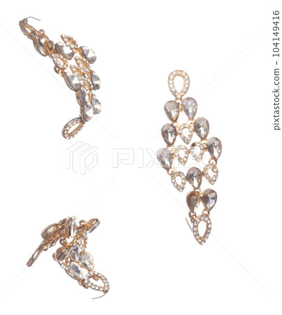 Fashion gold Earrings with beautiful work detail is value. Luxury golden earring is fashion trend and fly in air. White background isolated Fashion gold Earrings with beautiful work detail is value. Luxury golden earring is fashion trend and fly in air. White background isolated 104149416