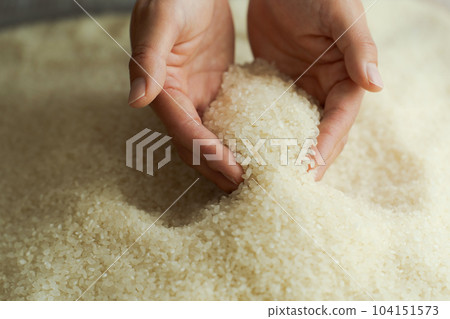 Hand photo of a woman scooping white rice Hand photo of a woman scooping white rice 104151573
