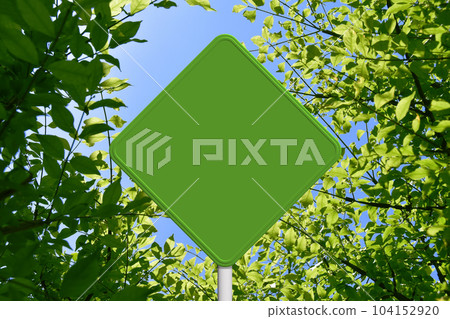 A green sign like a road sign against the background of young leaves A green sign like a road sign against the background of young leaves 104152920