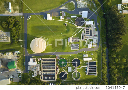 Aerial view of modern water cleaning facility at urban wastewater treatment plant. Purification process of removing undesirable chemicals, suspended solids and gases from contaminated liquid 104153047