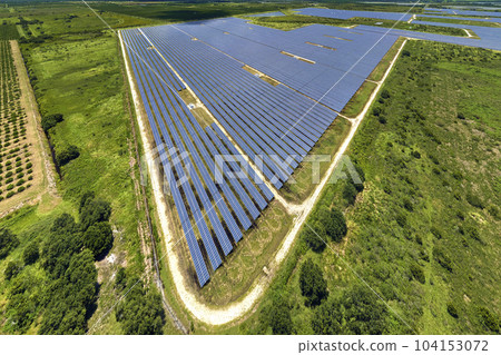 Aerial view of large sustainable electrical power plant with rows of solar photovoltaic panels for producing clean electric energy. Concept of renewable electricity with zero emission 104153072