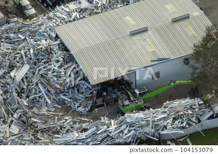 Aerial view of large pile of scrap aluminum metal from broken houses after hurricane Ian swept through Florida. Recycle of broken parts of mobile homes Aerial view of large pile of scrap aluminum metal from broken houses after hurricane Ian swept through Florida. Recycle of broken parts of mobile homes 104153079