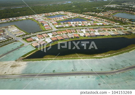 Aerial view of construction site with new tightly packed homes in Florida closed living clubs. Family houses as example of real estate development in american suburbs Aerial view of construction site with new tightly packed homes in Florida closed living clubs. Family houses as example of real estate development in american suburbs 104153269