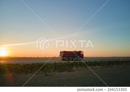 Aerial view of cargo truck driving on highway hauling goods. Delivery transportation and logistics concept Aerial view of cargo truck driving on highway hauling goods. Delivery transportation and logistics concept 104153305