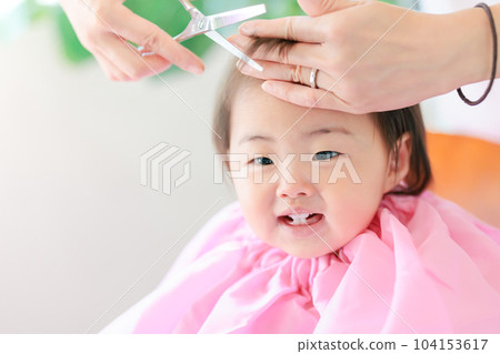 smiling baby first haircut 104153617