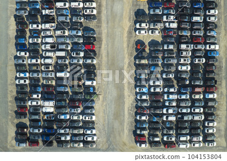 Aerial view of auction reseller company big parking lot with parked cars ready for remarketing services. Sales of secondhand vehicles Aerial view of auction reseller company big parking lot with parked cars ready for remarketing services. Sales of secondhand vehicles 104153804
