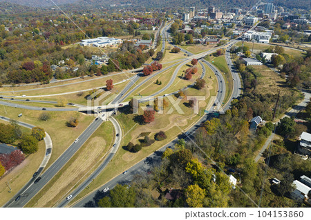 Aerial view of american freeway intersection in fall season in Asheville, North Carolina with fast moving cars and trucks. USA transportation infrastructure concept Aerial view of american freeway intersection in fall season in Asheville, North Carolina with fast moving cars and trucks. USA transportation infrastructure concept 104153860