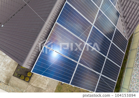Aerial view building roof with rows of blue solar photovoltaic panels for producing clean ecological electric energy. Renewable electricity with zero emission concept 104153894