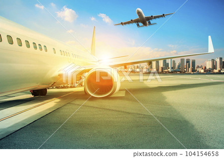 passenger plane parking at airport terminal and other approach for landing to runway 104154658